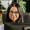 Woman at computer wearing a headset